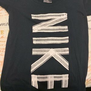black Nike shirt with white spelling